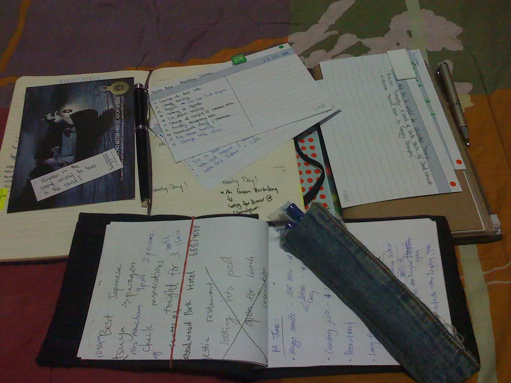 Notebooks and index cards filled with handwritten to-do lists