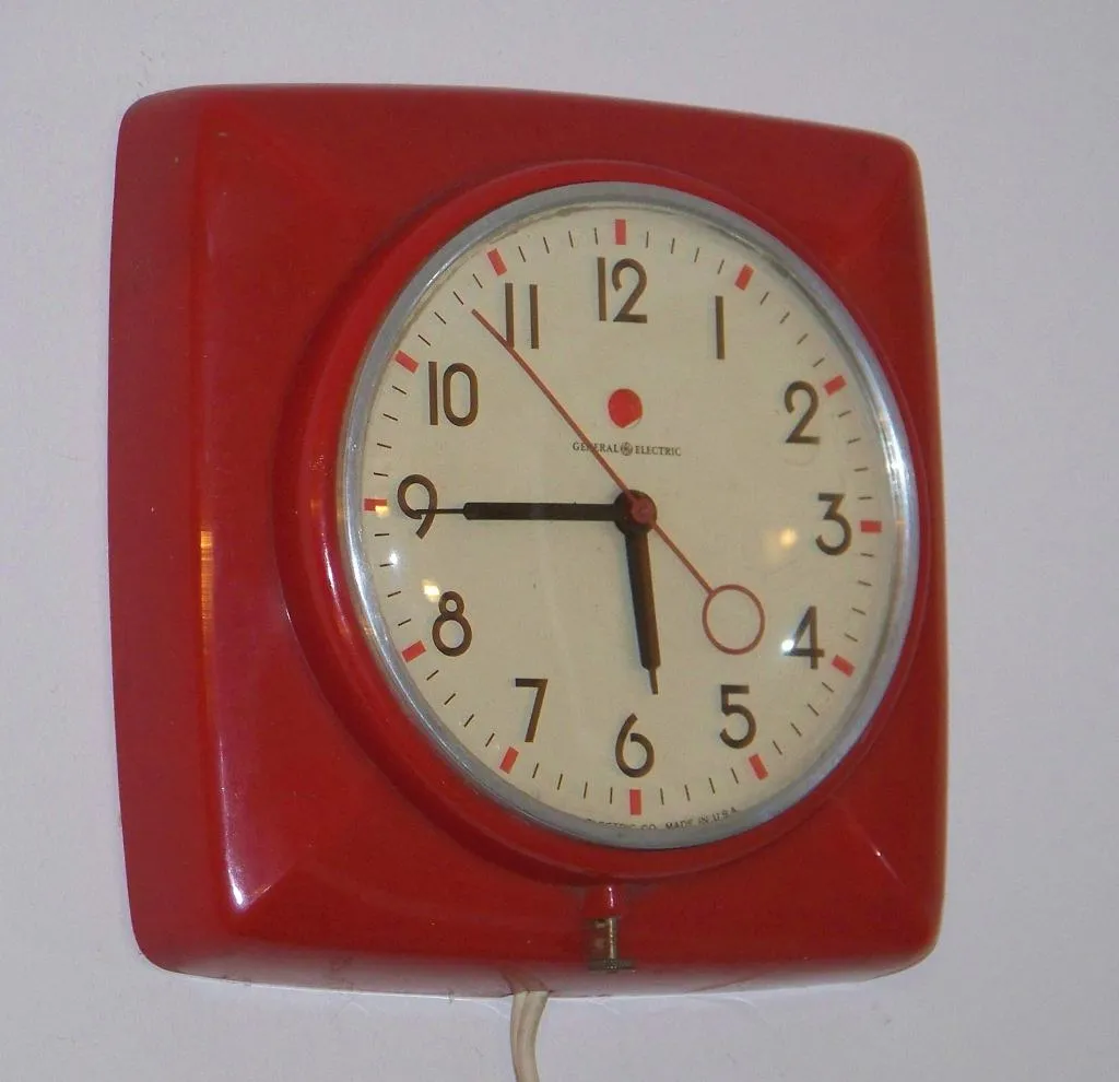 A red vintage kitchen wall clock