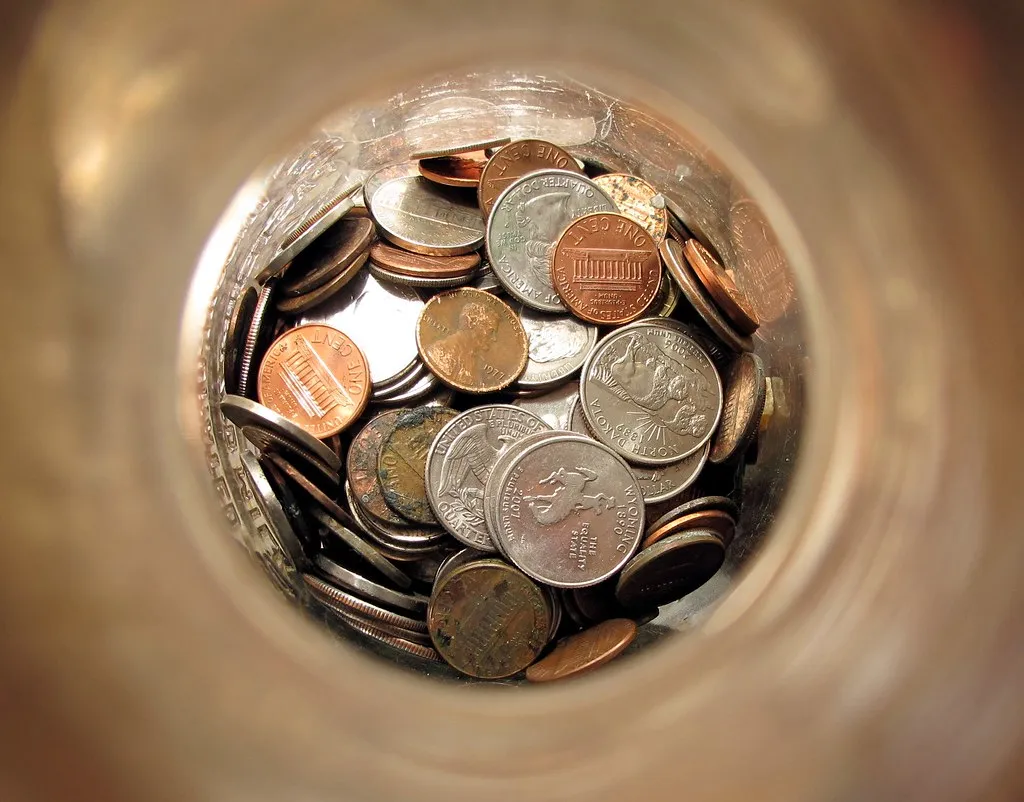 A jar filled with coins, seen from above