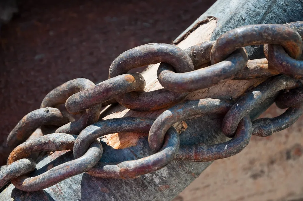 A close-up of large, rusted metal chain links